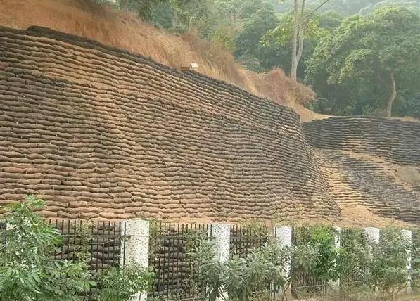 Building a retaining wall with geogrid involves several steps. Here is a general overview of the process:  Plan the wall: Determine the location and size of the wall, and calculate the amount of materials you will need. Consider the soil conditions, drainage, and any other factors that may affect the stability of the wall.  Excavate the site: Dig a trench along the length of the wall, making it deep enough to accommodate the first course of blocks and the geogrid. Level the bottom of the trench and compact the soil to create a stable base.  Install the base course: Lay the first course of blocks in the trench, making sure they are level and flush with the ground. Backfill behind the blocks with gravel or crushed stone, and compact it to create a stable base for the rest of the wall.  Install the geogrid: Unroll the geogrid and place it on top of the first course of blocks, extending it back into the soil behind the wall. Make sure the geogrid is centered over the joints between the blocks, and that there is enough excess material to fold over the next course of blocks.  Build the wall: Lay the second course of blocks on top of the first, making sure they are level and flush with the first course. Fold the excess geogrid over the top of the second course of blocks, and continue this pattern for each subsequent course of blocks.  Backfill the wall: Backfill behind the wall with gravel or crushed stone, compacting it in layers as you go. Make sure the backfill is level with the top of the blocks.  Finish the wall: Install any necessary drainage systems, such as a perforated pipe or drainage fabric, to prevent water from building up behind the wall. Install a capstone or other finish material on top of the wall to protect it from weathering and erosion.  Overall, building a retaining wall with geogrid requires careful planning and attention to detail. It's important to follow the manufacturer's instructions for the specific type of geogrid and blocks you are using, and to consult with a professional engineer if you have any doubts about the stability or safety of the wall.